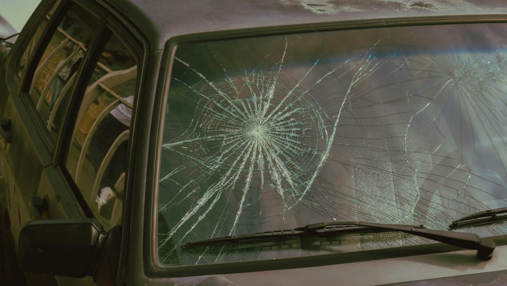 A broken windshield of a car with a broken windshield